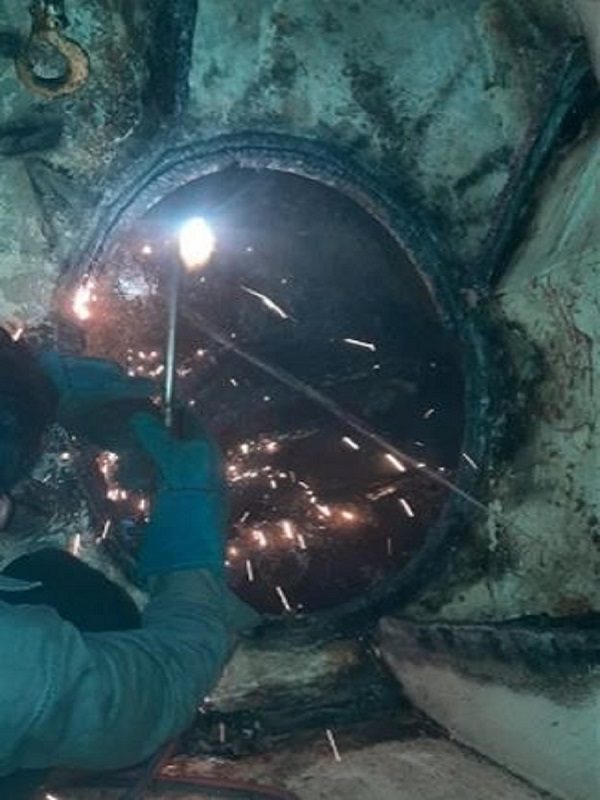 Workers working on Metal Pipe