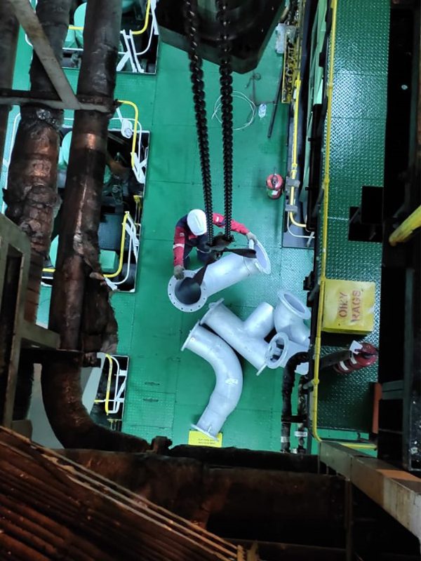 Workers Working on Metal Pipes