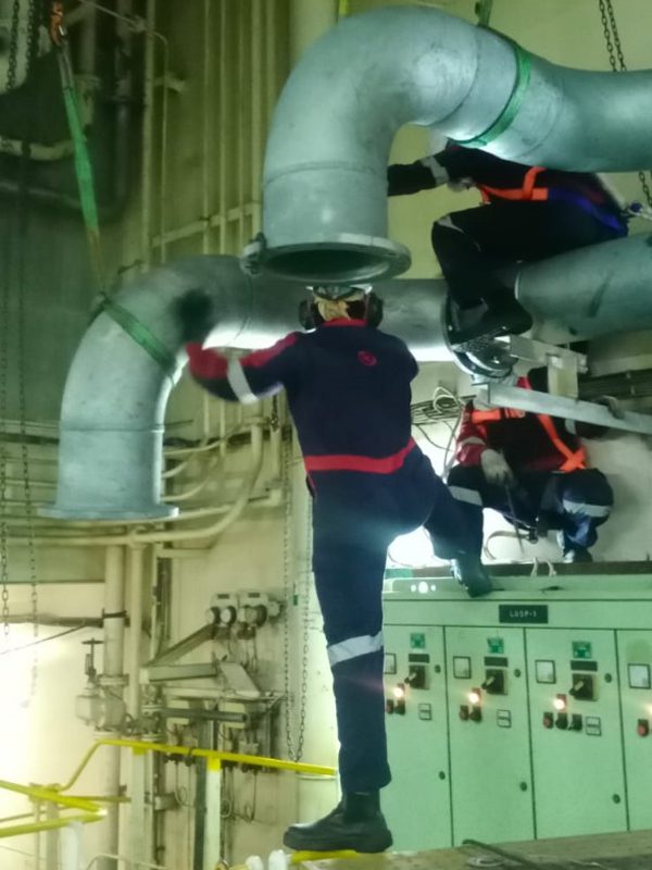 Workers Working on Metal Pipes