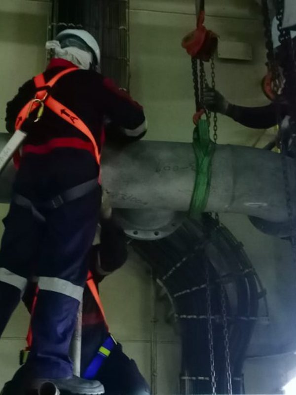 Workers Working on Metal Pipes