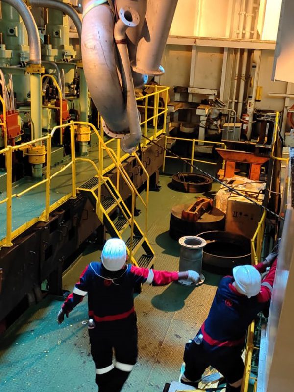 Workers Working on Metal Pipes